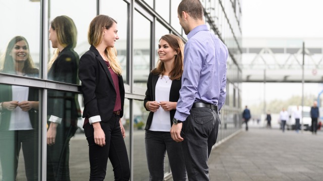 Three doctoral candidates in conversation
