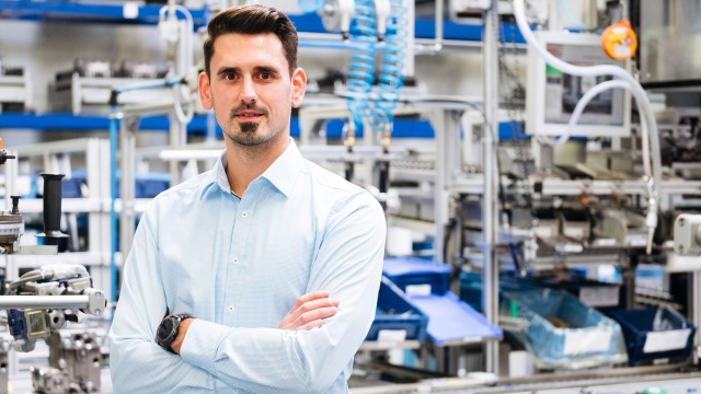 an employee inside a factory at the assembly line