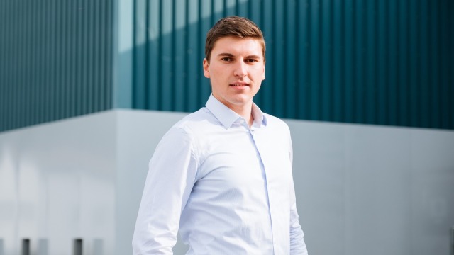 an employee in front of a plant